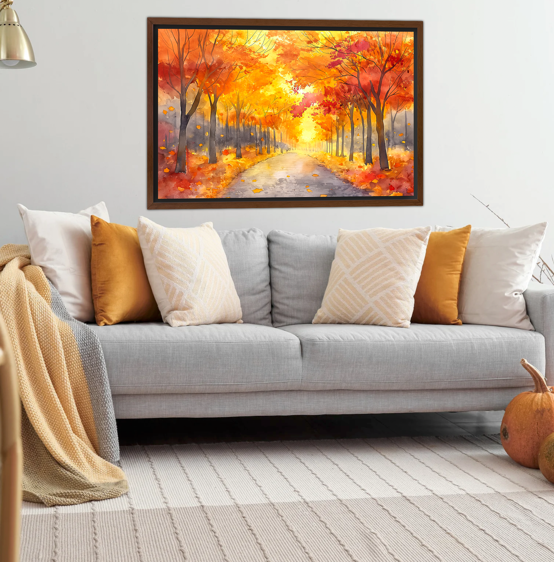 Walnut Framed Canvas Print on display overy grey couch in neutral living room featuring Autumn season fall watercolor art. Fall trees with a path. Art for sale at customconcepts.art